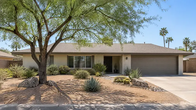 Single-story ranch home in central Tempe with a fresh desert front yard, a mesquite tree and decomposed granite
